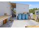 Exterior featuring blue storage barrels and open shed space at 2906 Waterside Dr, Englewood, FL 34224
