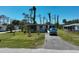 Quaint single-story home with well-manicured lawn and flowering plants at 2906 Waterside Dr, Englewood, FL 34224