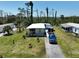 Lovely house with a well manicured lawn, blue truck, and flowering plants at 2906 Waterside Dr, Englewood, FL 34224