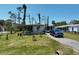 Inviting single-story home with a well-kept lawn, a blue truck and flowering plants at 2906 Waterside Dr, Englewood, FL 34224