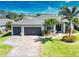 Aerial view of home showcasing its two-car garage, landscaping, and well manicured lawn at 35 Medalist Rd, Rotonda West, FL 33947
