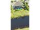 Aerial view of a home's screened-in pool overlooking a backyard and canal at 35 Medalist Rd, Rotonda West, FL 33947