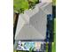 Stunning aerial view of a home with a screen-enclosed pool, lush landscaping, and a well-maintained roof at 35 Medalist Rd, Rotonda West, FL 33947