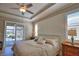 Cozy bedroom featuring tray ceilings, modern ceiling fan, and lots of natural light at 35 Medalist Rd, Rotonda West, FL 33947