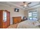 Bedroom with hardwood floors, TV, and outdoor view at 35 Medalist Rd, Rotonda West, FL 33947