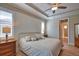 Bedroom featuring hardwood floors, tray ceilings, and a walk-in bathroom at 35 Medalist Rd, Rotonda West, FL 33947