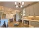 Open dining area with table and view to gourmet kitchen with stainless steel appliances and white cabinetry at 35 Medalist Rd, Rotonda West, FL 33947