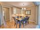 Elegant dining room with wood floors, wainscoting, and a stylish chandelier at 35 Medalist Rd, Rotonda West, FL 33947