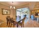 Cozy dining room with view to the screened lanai for indoor-outdoor living at 35 Medalist Rd, Rotonda West, FL 33947