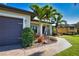 Charming home exterior featuring a two-car garage, desert landscaping and a paved walkway at 35 Medalist Rd, Rotonda West, FL 33947