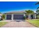 Beautiful home with a large driveway, two-car garage and well-maintained landscaping at 35 Medalist Rd, Rotonda West, FL 33947