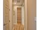 Hallway with wood-look floors leading to a walk-in closet featuring wire shelving at 35 Medalist Rd, Rotonda West, FL 33947