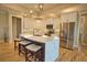 Modern kitchen features an island with quartz countertops, stainless appliances, and wood flooring at 35 Medalist Rd, Rotonda West, FL 33947