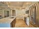 Modern kitchen with a large island, white cabinetry, stainless steel appliances, and tiled backsplash at 35 Medalist Rd, Rotonda West, FL 33947