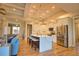 Modern kitchen features a large island, stainless steel appliances, and stylish pendant lighting at 35 Medalist Rd, Rotonda West, FL 33947