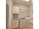Bright laundry room features granite countertops, shaker cabinets, and washer and dryer at 35 Medalist Rd, Rotonda West, FL 33947