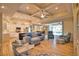Open-concept living room with coffered ceiling, hardwood floors, and a seamless transition to the outdoor living space at 35 Medalist Rd, Rotonda West, FL 33947
