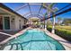 The backyard boasts a sparkling pool and seamlessly connects indoor and outdoor spaces at 35 Medalist Rd, Rotonda West, FL 33947