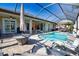 A beautiful screened-in pool area with a firepit and plenty of seating at 35 Medalist Rd, Rotonda West, FL 33947