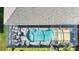 Aerial view of an enclosed pool area with a dining set, seating, and partial sunshade at 35 Medalist Rd, Rotonda West, FL 33947