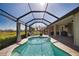 Covered pool with lighting and bar, adjacent to the home's interior, creating an inviting atmosphere at 35 Medalist Rd, Rotonda West, FL 33947