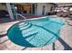The backyard boasts a sparkling pool and seamlessly connects indoor and outdoor spaces at 35 Medalist Rd, Rotonda West, FL 33947
