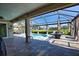 Covered patio with a pool, and a seating area in a screened-in lanai at 35 Medalist Rd, Rotonda West, FL 33947