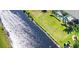 Scenic waterfront property with meticulously manicured lawn, leading to a screened-in pool area at 35 Medalist Rd, Rotonda West, FL 33947