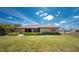 This home features a manicured lawn, neat landscaping, and a fenced backyard at 39 Bunker Pl, Rotonda West, FL 33947
