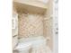 Charming bathroom featuring combined shower and tub, with practical shelves for storage and assistance bars at 39 Bunker Pl, Rotonda West, FL 33947