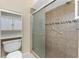 Updated bathroom with a modern glass-enclosed shower and integrated shelves for convenient storage at 39 Bunker Pl, Rotonda West, FL 33947