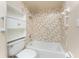 Bathroom featuring combined shower and tub, practical shelves, and assistance bars at 39 Bunker Pl, Rotonda West, FL 33947