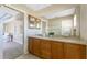 Bright bathroom features double sinks and generous counter space plus a view into the adjacent bedroom at 39 Bunker Pl, Rotonda West, FL 33947