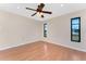 This bedroom features wood-look floors, neutral walls, a ceiling fan and windows for natural light at 39 Bunker Pl, Rotonda West, FL 33947