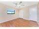 Well-lit bedroom featuring hardwood floors, a ceiling fan, and a double door closet at 39 Bunker Pl, Rotonda West, FL 33947