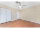 Spacious bedroom featuring a closet, hardwood floors, a ceiling fan, and light neutral paint at 39 Bunker Pl, Rotonda West, FL 33947
