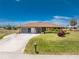 Charming single-story home featuring a well-maintained lawn and a convenient driveway at 39 Bunker Pl, Rotonda West, FL 33947