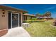 Charming front entrance with verdant landscaping, secure gate, and stone accents at 39 Bunker Pl, Rotonda West, FL 33947