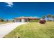 Charming single-story home with a well-manicured lawn, mature landscaping, and inviting curb appeal at 39 Bunker Pl, Rotonda West, FL 33947
