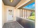 Cozy front porch entrance with tiled floor and decorative glass front door at 39 Bunker Pl, Rotonda West, FL 33947