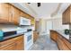 Spacious kitchen offers a white oven and microwave, beautiful wood cabinetry and neutral flooring at 39 Bunker Pl, Rotonda West, FL 33947