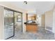 Open kitchen with granite countertops, stainless steel sink, and an adjacent outdoor patio at 39 Bunker Pl, Rotonda West, FL 33947
