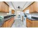 Well-lit kitchen with matching appliances, stone countertops and tiled flooring at 39 Bunker Pl, Rotonda West, FL 33947