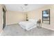 Serene main bedroom featuring a ceiling fan, neutral paint and carpet, with direct patio access at 39 Bunker Pl, Rotonda West, FL 33947