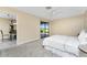 Comfortable main bedroom with a ceiling fan, neutral paint, carpet and sliding glass door to the patio at 39 Bunker Pl, Rotonda West, FL 33947