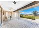 This covered patio offers a relaxing outdoor space with stone pavers and views of the manicured backyard at 39 Bunker Pl, Rotonda West, FL 33947