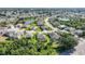 Stunning aerial view of a residential area showcasing houses, ponds, and tree-lined streets at 4004 Landor Ct, Venice, FL 34293