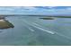 Stunning aerial view showcasing turquoise waters with boats cruising leaving foamy wakes on a clear day at 4004 Landor Ct, Venice, FL 34293