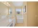 Bathroom with soaking tub, vanity, tile floors, and large mirror at 4004 Landor Ct, Venice, FL 34293