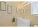 Bathroom features a white vanity, large mirror and bright vanity lighting at 4004 Landor Ct, Venice, FL 34293